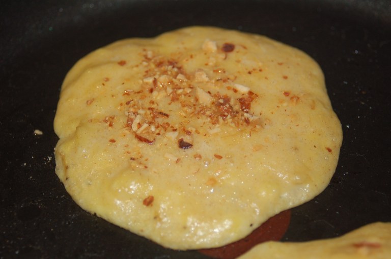 Sprinkle toasted and finely chopped almonds to add a nice crunch to the pancake.